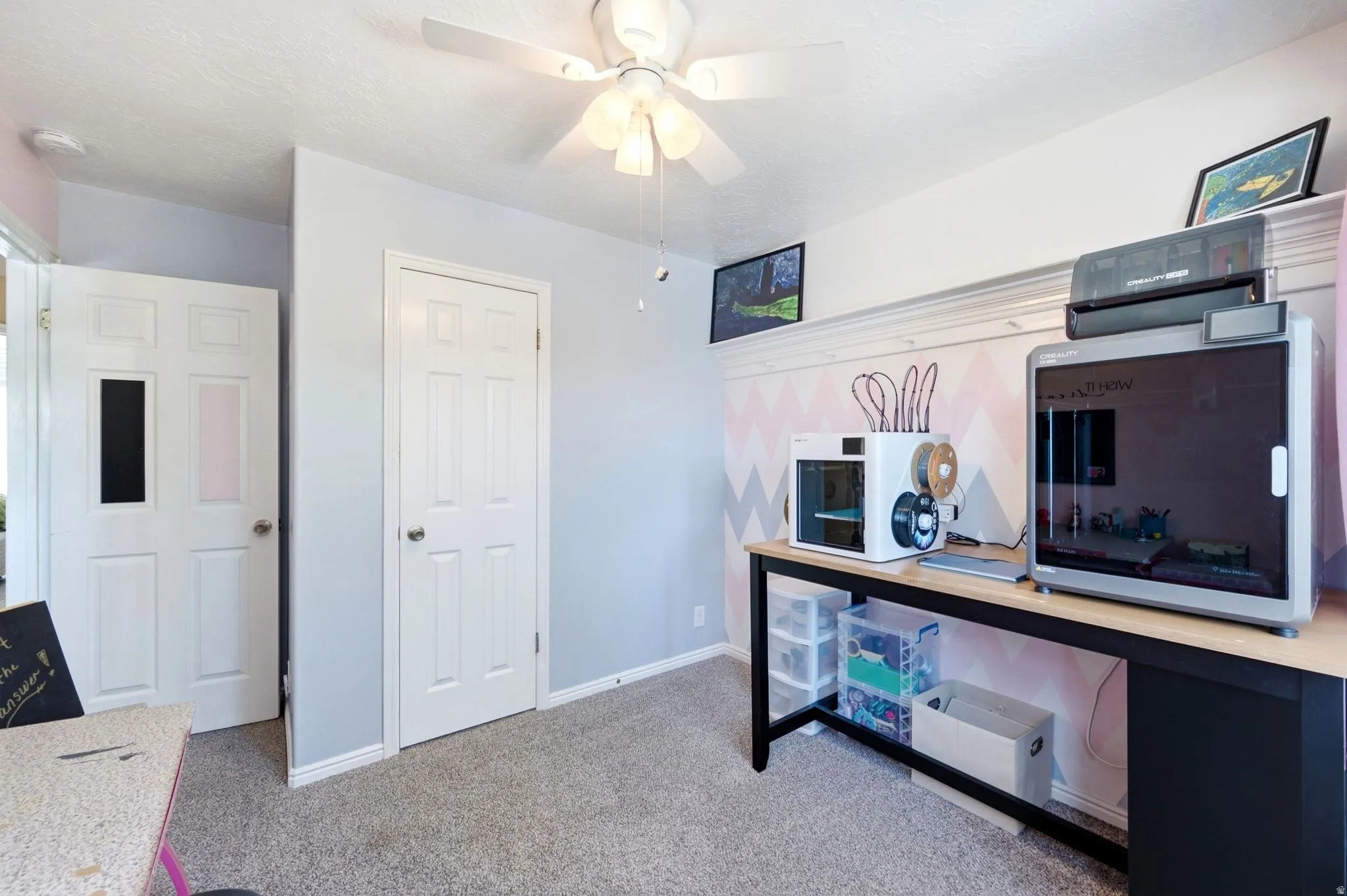 Ceiling fan with light kit, panel doors, carpeted flooring, decorative wall treatment