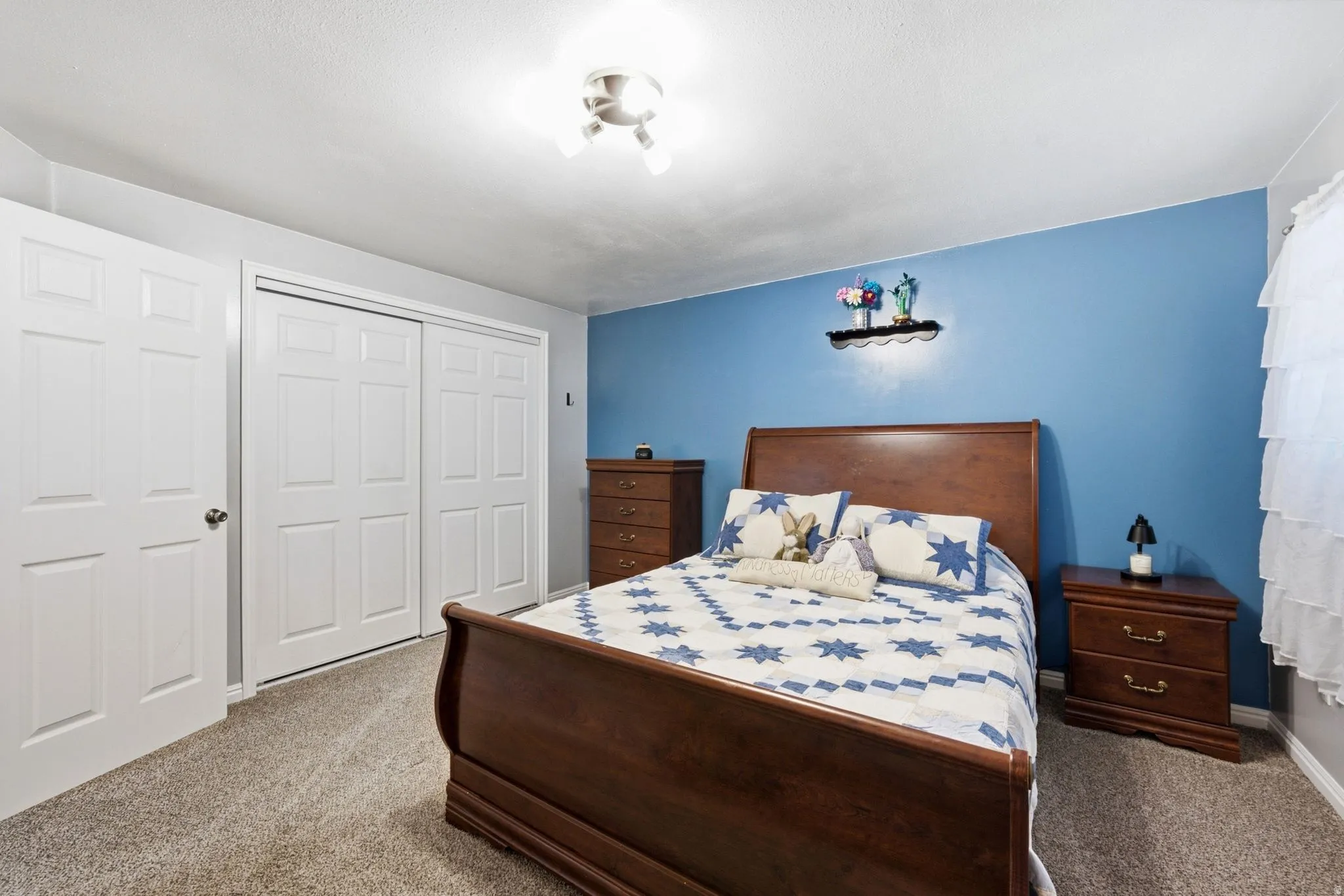 Wall-to-wall carpeting, white interior doors, and a ceiling-mounted light fixture