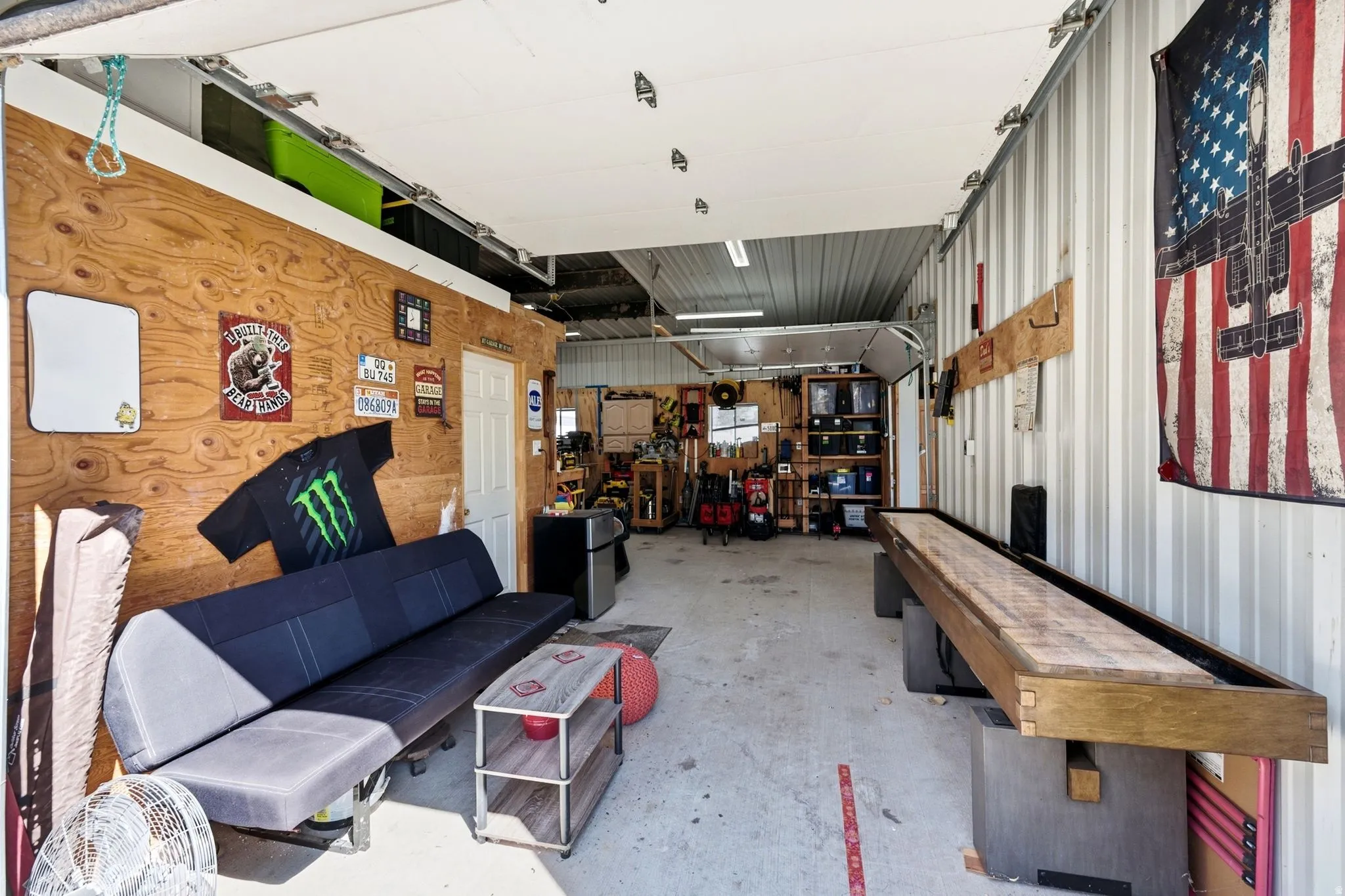 Concrete flooring and a paneled wood-finish wall