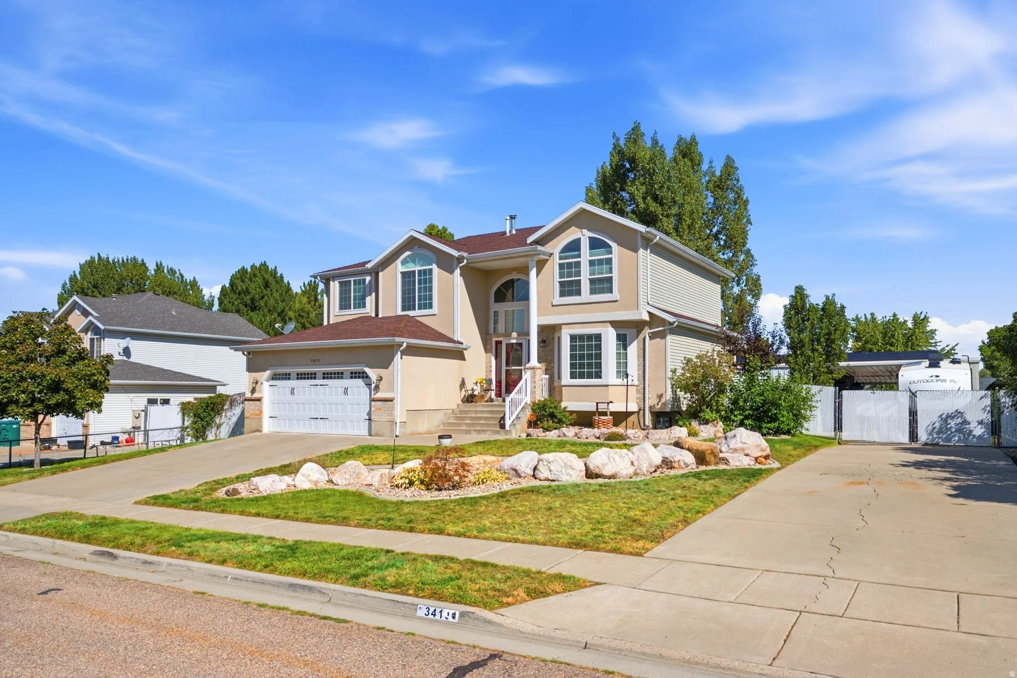 Two-story residence with a stucco exterior and prominent arched windows