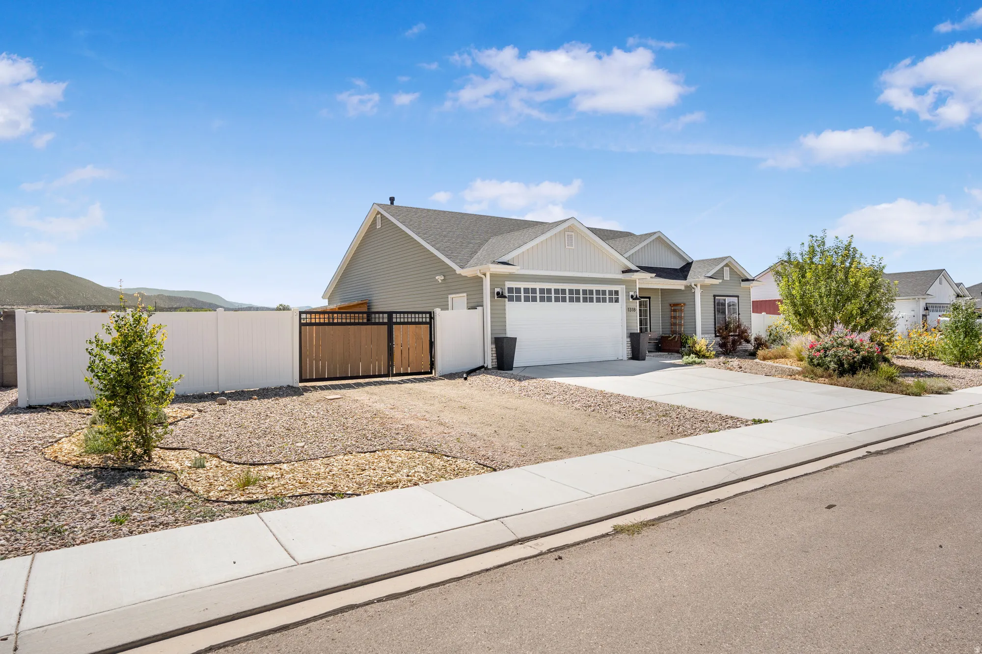 Contemporary ranch-style residence featuring light gray siding and white trim