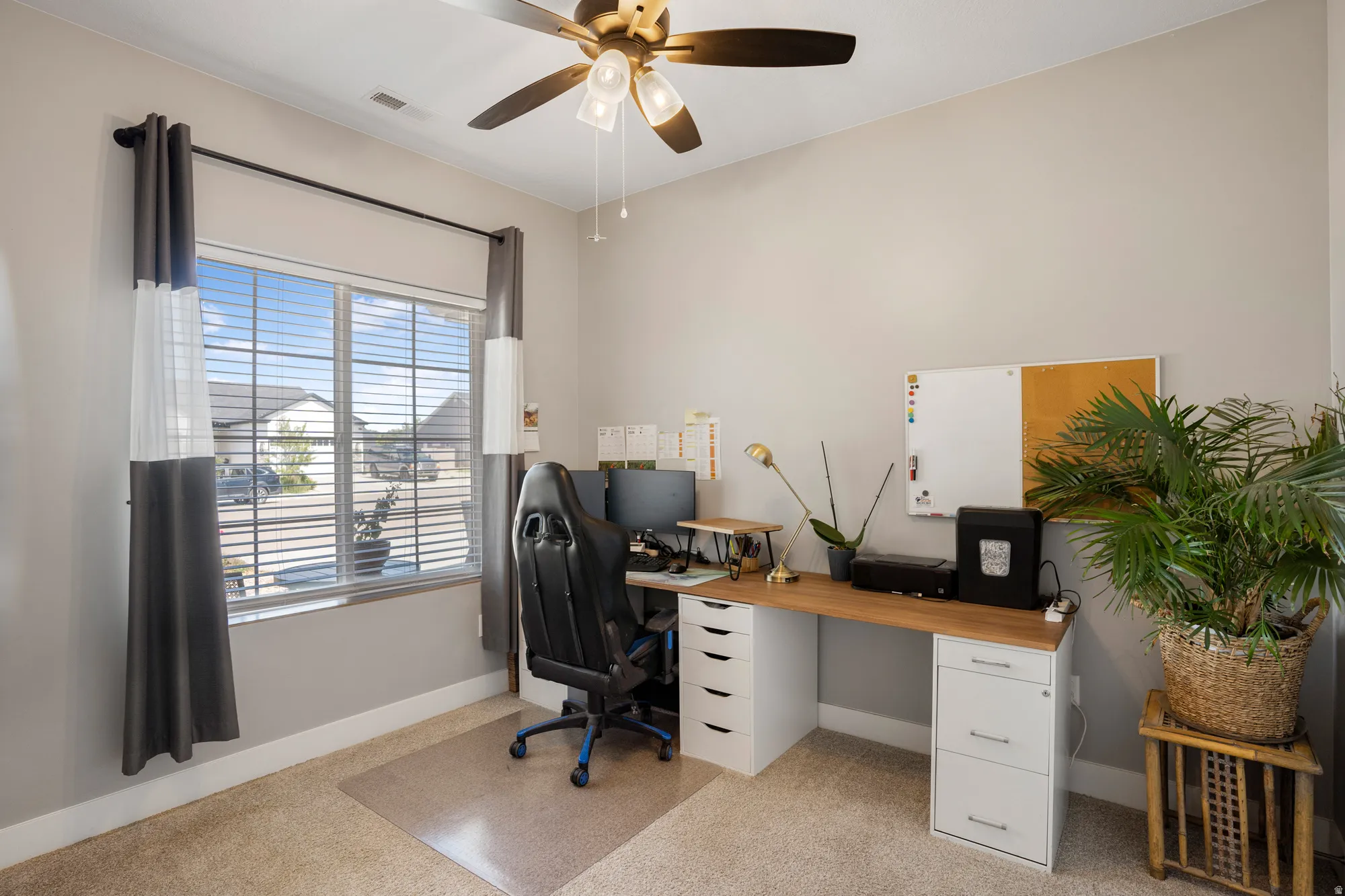 Neutral wall color, ceiling fan, and carpeted flooring