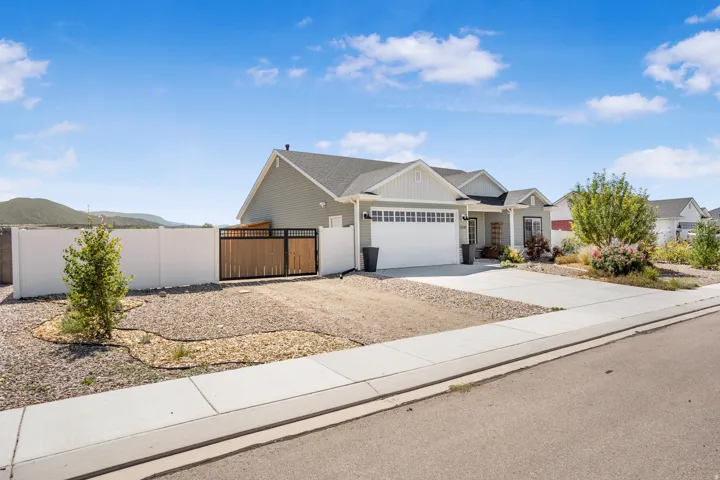 Contemporary ranch-style residence featuring light gray siding and white trim