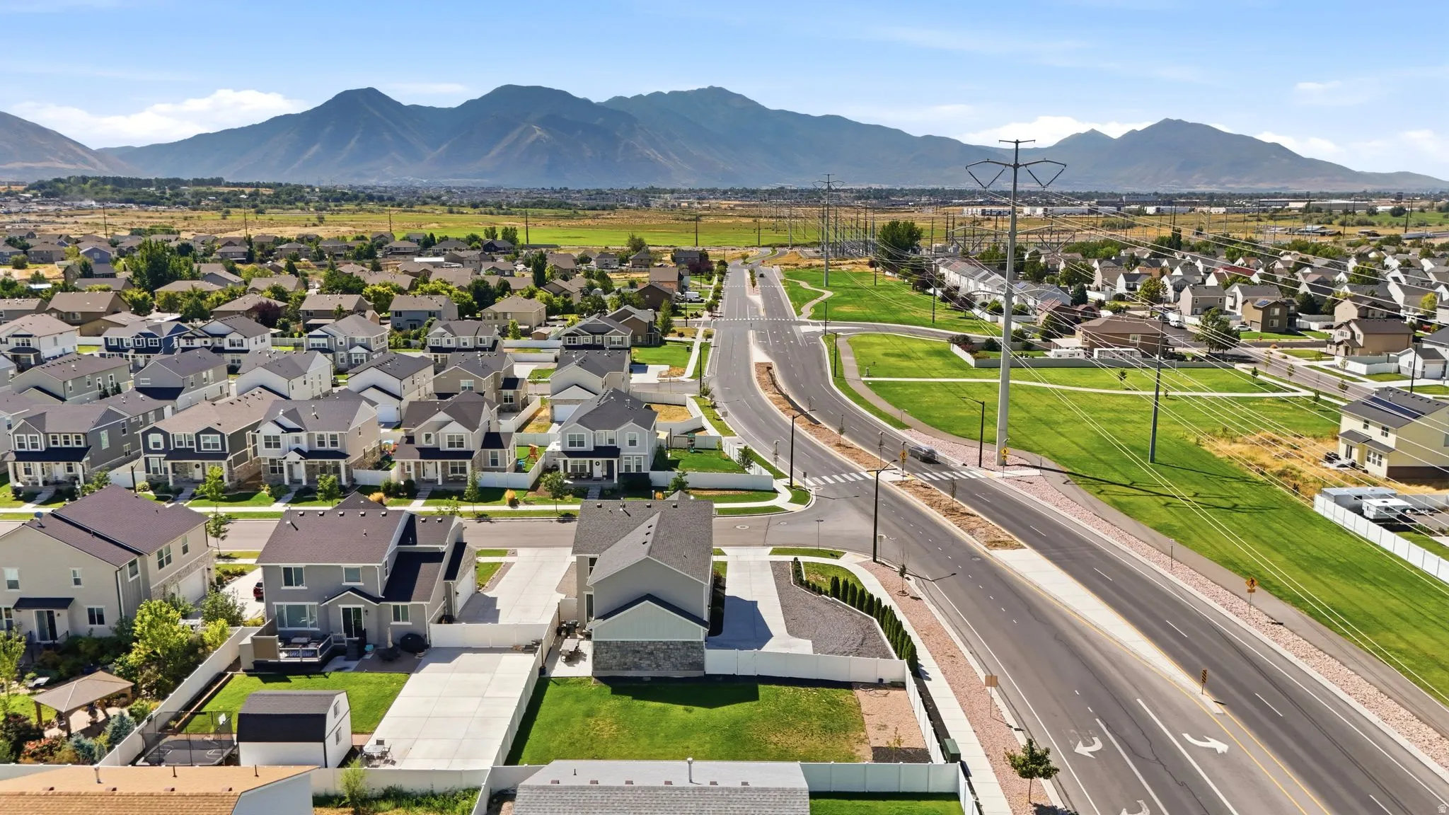 Expansive developed neighborhood featuring residential structures, paved roads, and green spaces