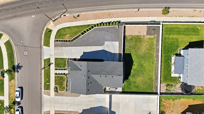 Asphalt shingle roof with a prominent chimney and multiple roof planes