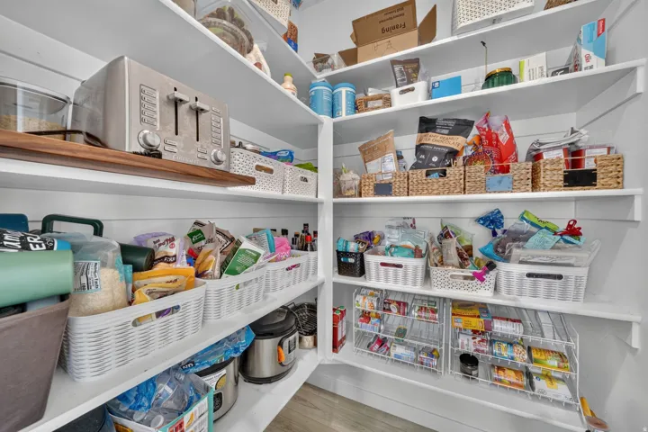 Custom built-in shelving with varied depths and a wood-finish accent shelf