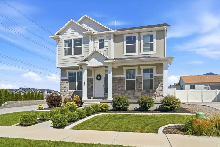 Two-story stucco and stone-faced exterior with white trim