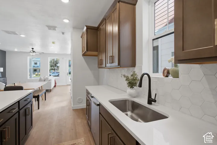 Kitchen featuring wood-finish cabinetry, white countertops, and a hexagonal tile backsplash