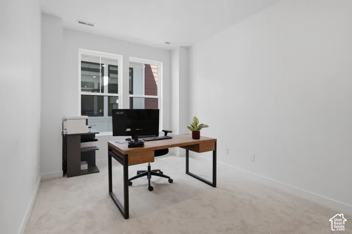 Carpeted room featuring multiple windows and recessed lighting
