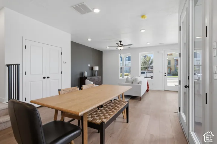 Open-concept living space with wood-finish flooring, recessed lighting, and a ceiling fan