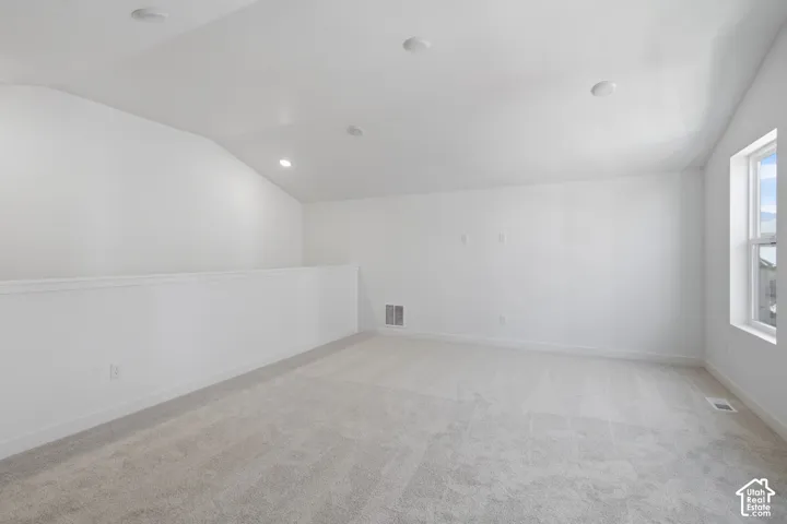 Huge 3rd floor game room, 2nd family room, or office. Featuring light-colored carpeting, white walls, recessed ceiling lights, and a window providing natural illumination