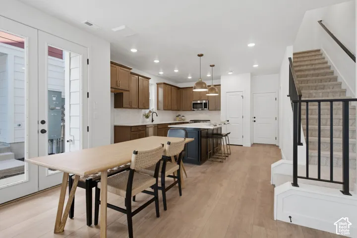 Kitchen featuring a huge, central island, stainless steel appliances, and a tile backsplash