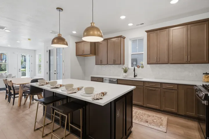Kitchen featuring a center island, wood-finish flooring, recessed lighting, and pendant fixtures