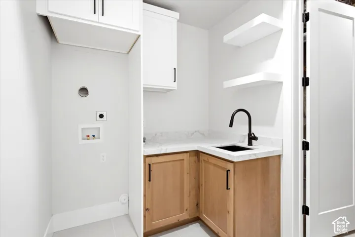Corner vanity with stone-finish countertop, undermount sink, and matte black faucet