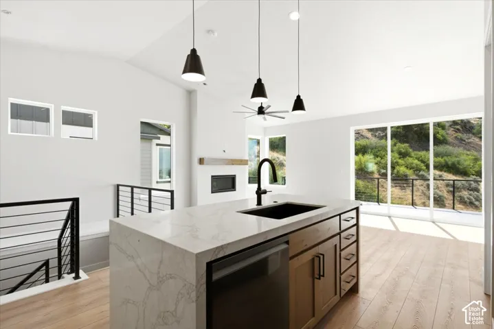 Kitchen island with a waterfall countertop, integrated sink, and matte black faucet