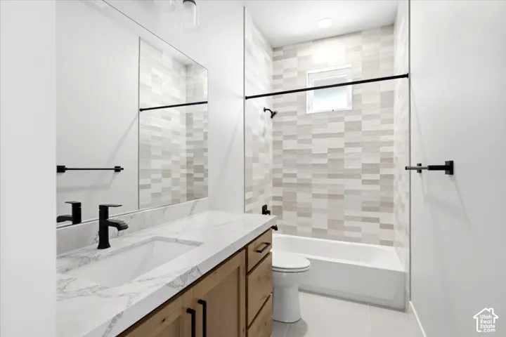 Wood-finish vanity with an integrated rectangular sink, stone-finish countertop, and matte black fixtures