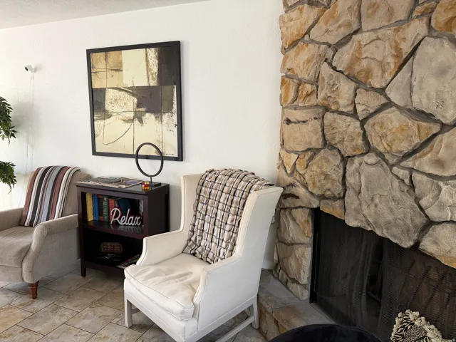 Stacked stone fireplace with a black fire screen