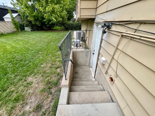Walk in basement entrance. Exterior siding with horizontal panels