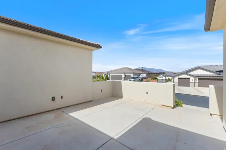 Private concrete patio area with stucco walls