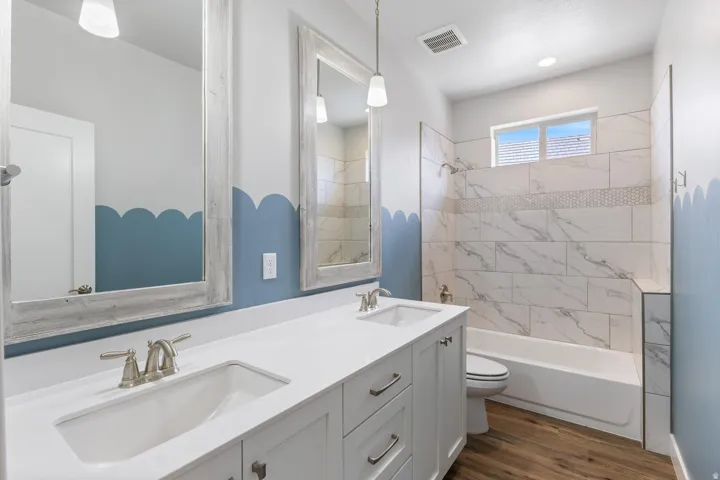 Dual vanity with undermount sinks, white countertop, and brushed nickel fixtures