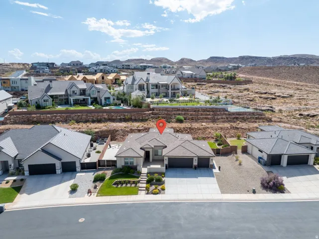 Single-story residence featuring a neutral exterior, multi-pitched roofline, an attached garage, and a concrete driveway