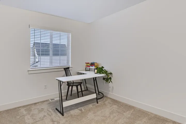Neutral-toned walls with light-colored carpeting