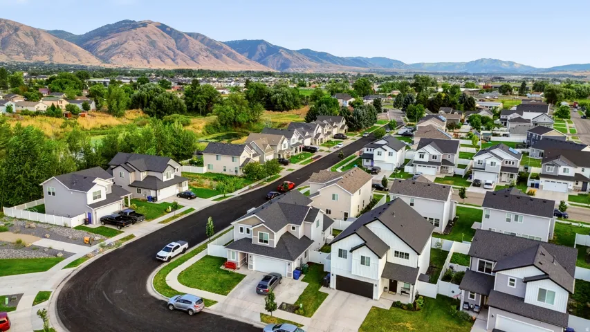 Residential neighborhood with varied architectural styles, paved streets, and manicured lawns