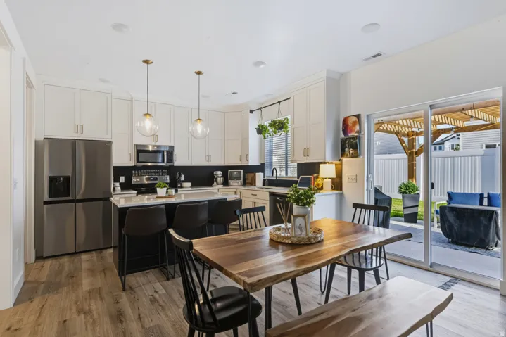 Wood-finish flooring throughout the open-concept kitchen and dining area