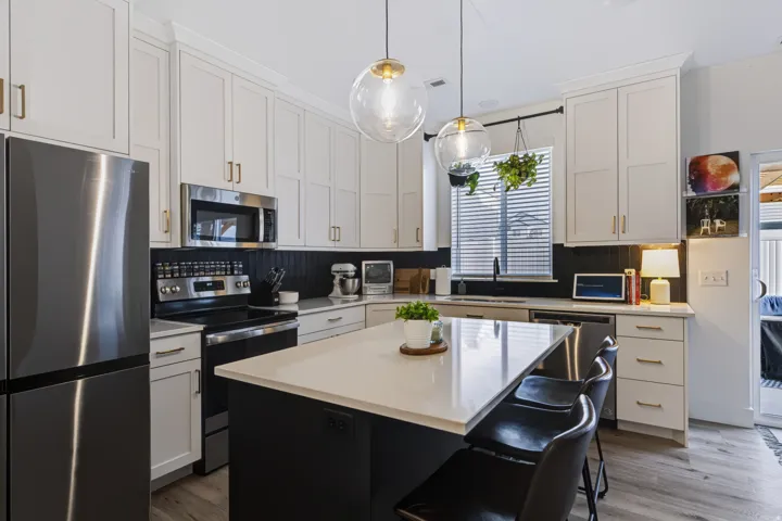 White shaker cabinetry with gold-finish hardware