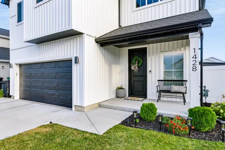 Contemporary exterior with vertical white siding and black trim accents