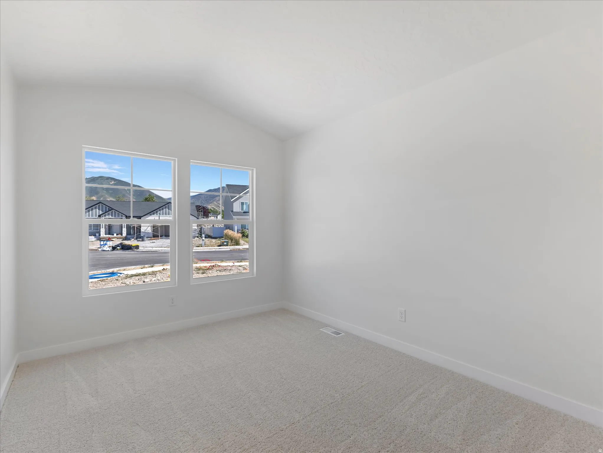 Vaulted ceilings, light-colored carpeting, and dual windows
