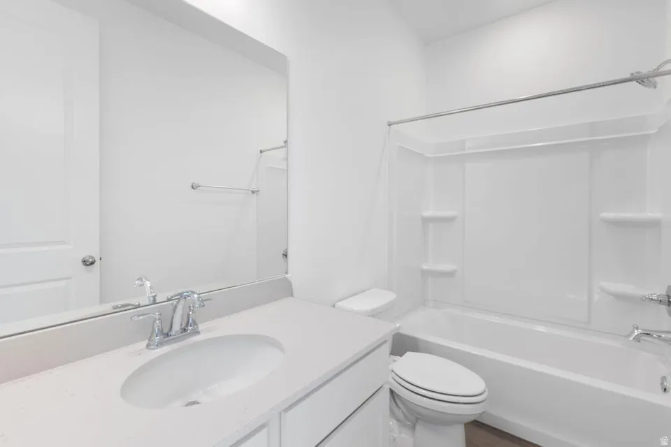 Bathroom featuring a vanity with an integrated sink, polished chrome faucet, and a wall-mounted mirror