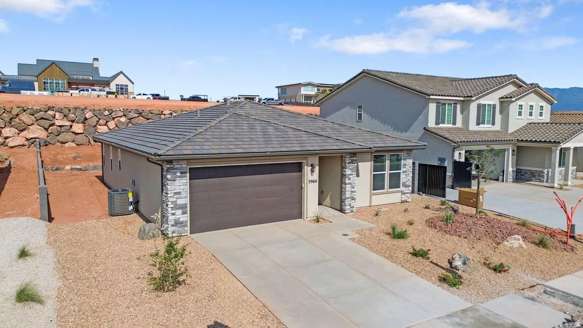 Single-story residence featuring a concrete driveway and an attached garage