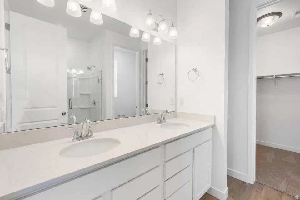 Dual vanity with undermount sinks, chrome fixtures, and a spacious countertop