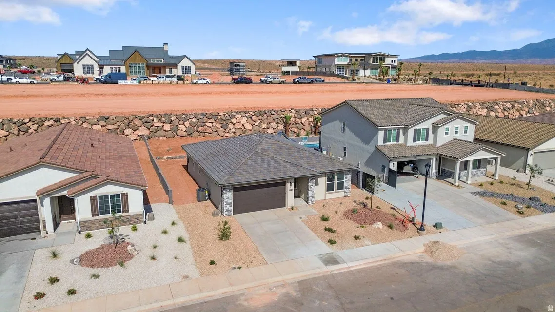 Single-story residence featuring a two-car garage and a paved driveway