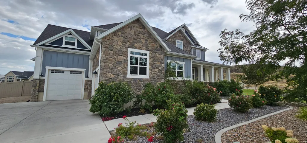 Stone and siding exterior with gabled roof lines