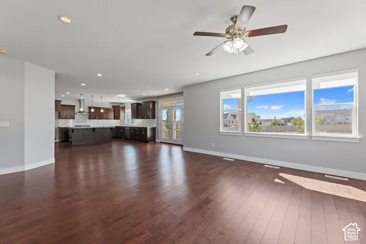 Expansive living area featuring wood-finish flooring, recessed lighting, and a ceiling fan