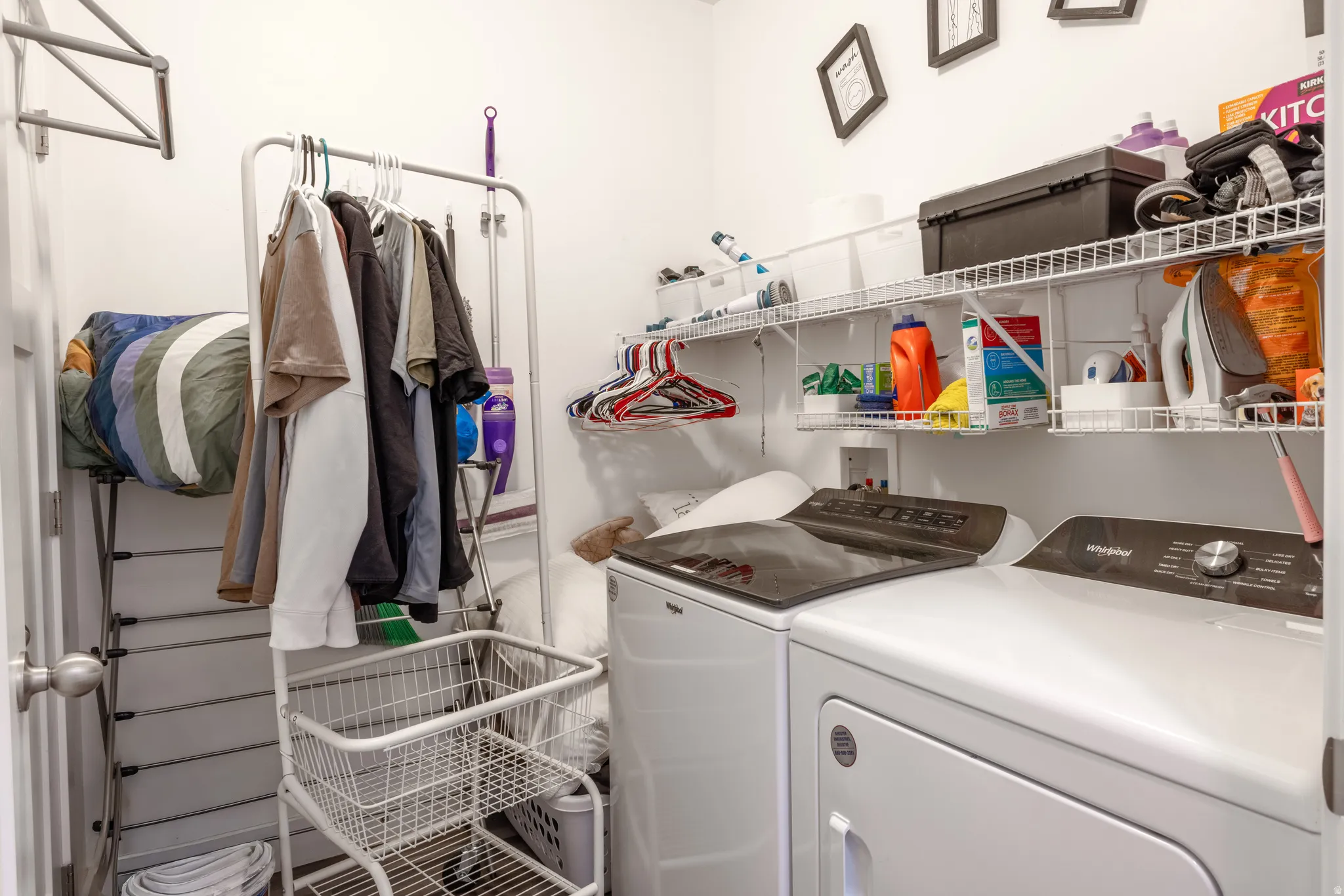 Integrated washer and dryer appliances with upper wire shelving