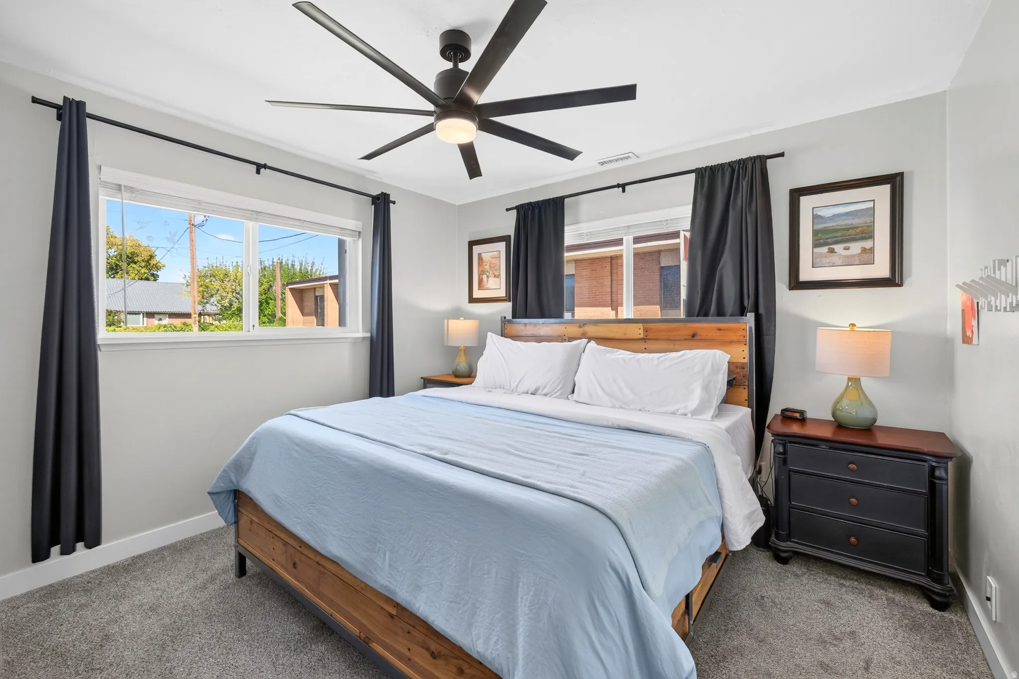 Recessed lighting, ceiling fan with integrated lighting, window with white trim, wood-finish headboard, and gray carpeting