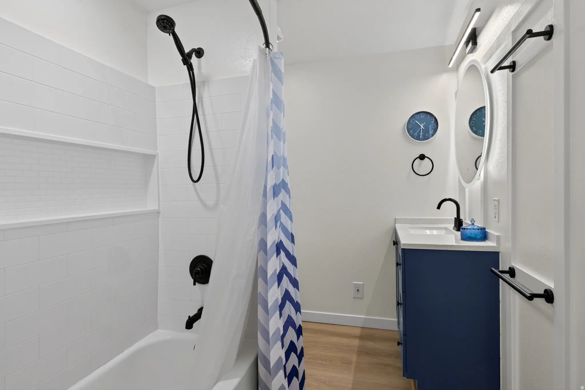 White tiled shower with a built-in niche and matte black fixtures