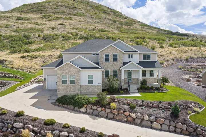 Stone and siding exterior with a covered front entry