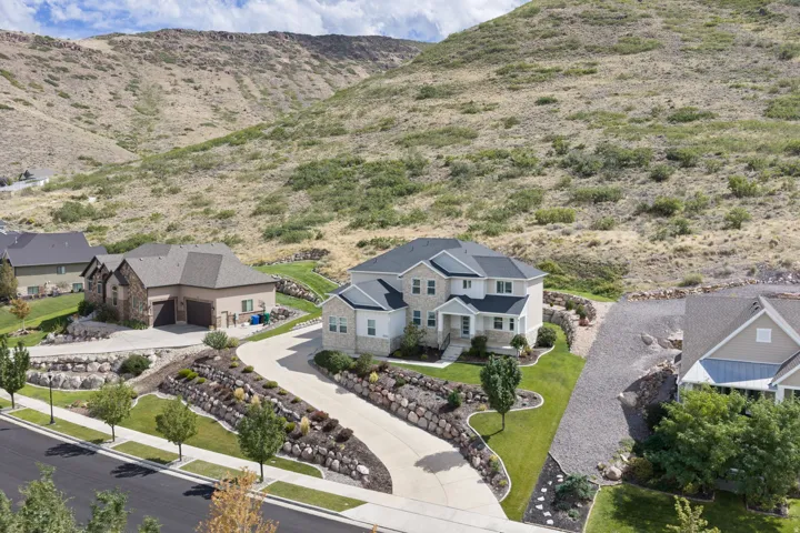 Two-story residence with a light-toned exterior and dark roof