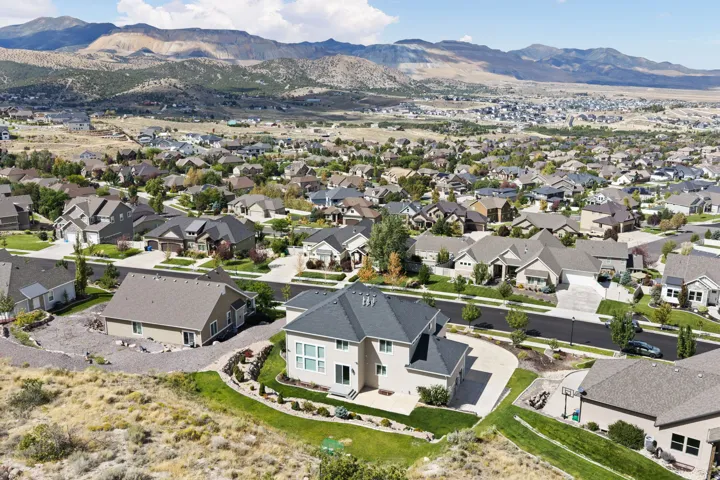 Expansive residential community with diverse architectural styles, mature landscaping, and paved streets