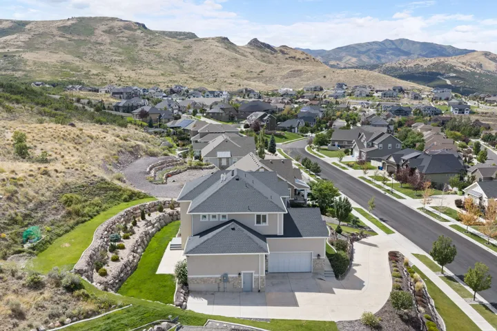 Modern residence with multi-level stone retaining walls and mature landscaping
