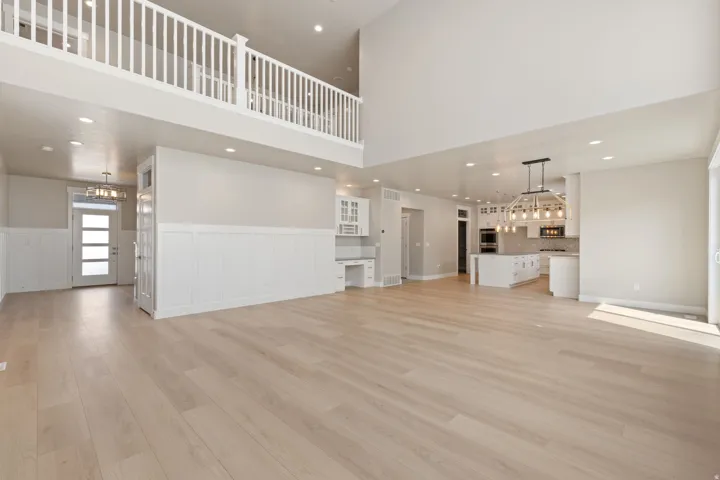 Vaulted ceilings and wood-finish flooring complement the open-concept design