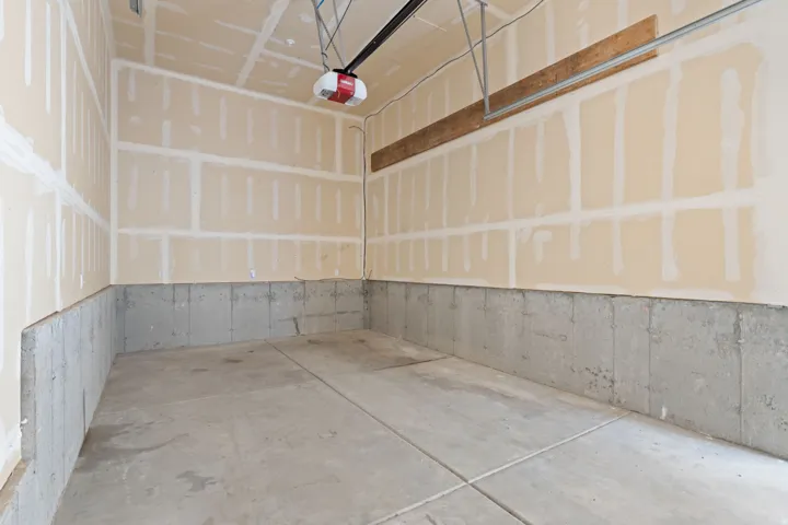 Concrete flooring with a finished concrete foundation wall and drywall