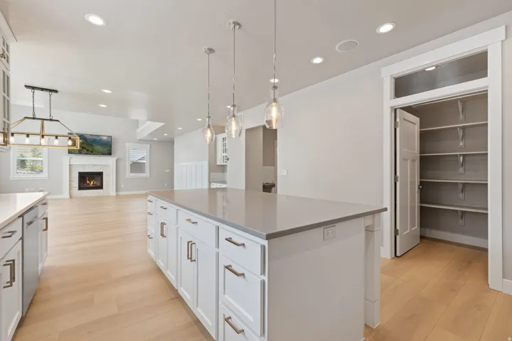 Kitchen island with quartz countertop and pendant lighting