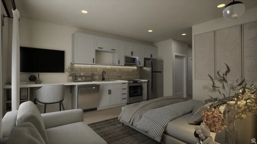 Integrated kitchen area with light cabinetry and stainless steel appliances