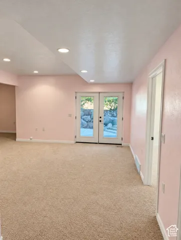 Interior space featuring recessed lighting, wall-to-wall carpeting, and double glass doors providing an exterior egress