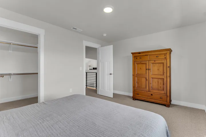 Neutral wall paint, recessed lighting, and carpeted flooring
